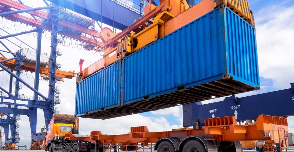 A container is loaded onto a vehicle.