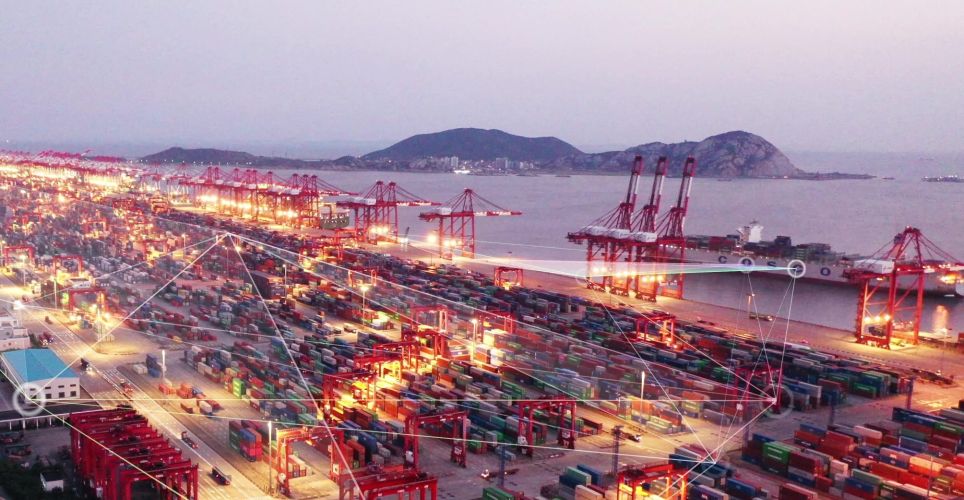 Illuminated container port at dusk. Lines form a network and represent a luminous network of logistics.