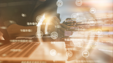 Person sits bent over the cell phone and looks over a code. Symbols are flying around. For example: laptop or location icon...,