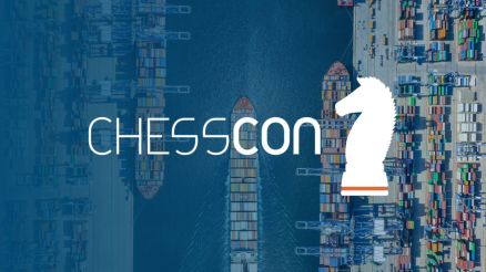 Aerial view of a bustling container port featuring the CHESSCON logo and a white knight chess piece.