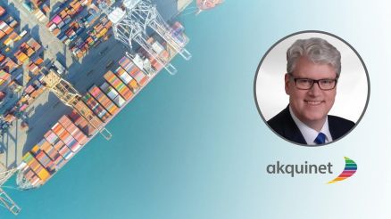 Bird's-eye view of the container port, where a ship has docked and is being loaded. AKQUINET logo and above it a picture of Oliver Jelsch with white hair, glasses, and a blue tie.