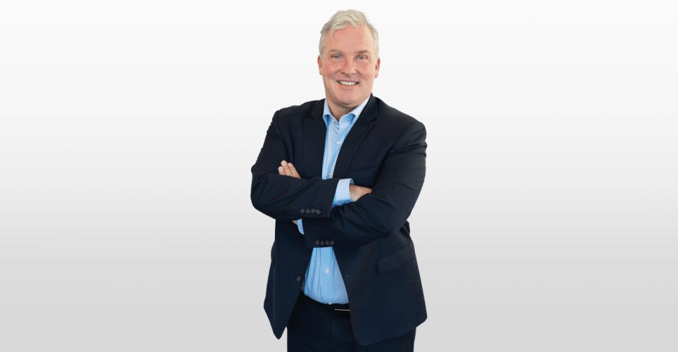 Dr. Lawrence Henesey smiling, ready to lead the sales department, signifying his start in guiding our customers through their digital transformation journeys.