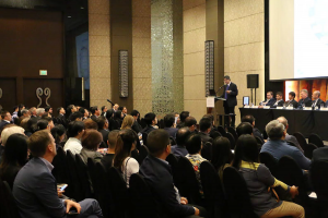 Many people sit in front of the stage listening to the presentations at the Phillipine Ports and Shipping 2019 Conference in Manila.